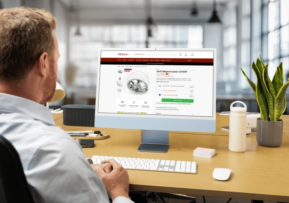 Edoro.sk product page on an iMac, seen over the shoulder of a man at his desk