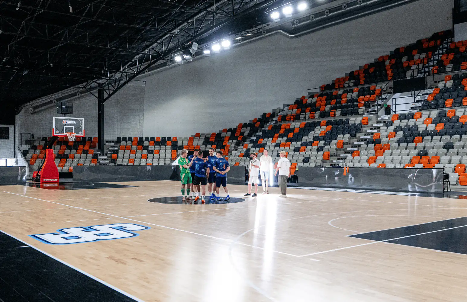 The team in the arena between takes